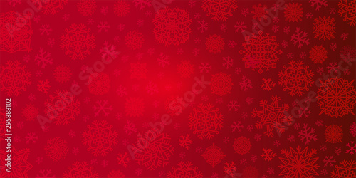 Christmas background of big and small snowflakes in red colors