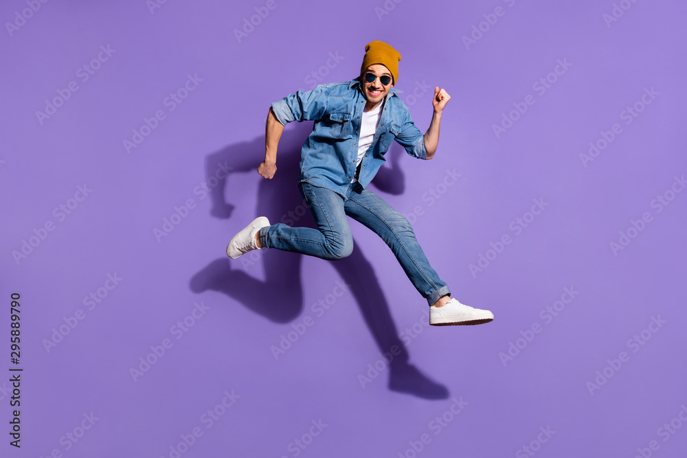 Full length body size photo of fast quick handsome cheerful man running to shopping center nearby for purchasing isolated over purple vivid color background