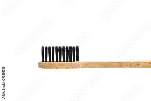 Bamboo toothbrush with black brush isolated on white background