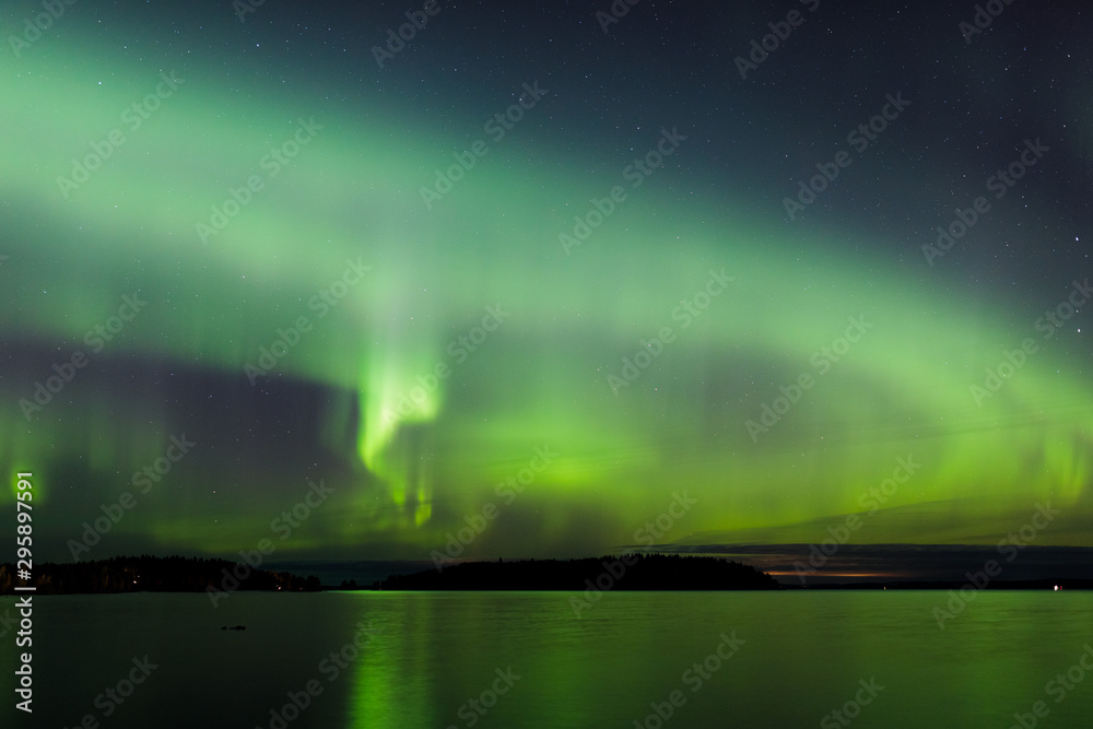 Northern lights over lake in Finland