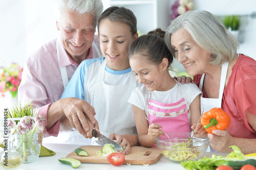 Portrait of family cooking together in kitchen