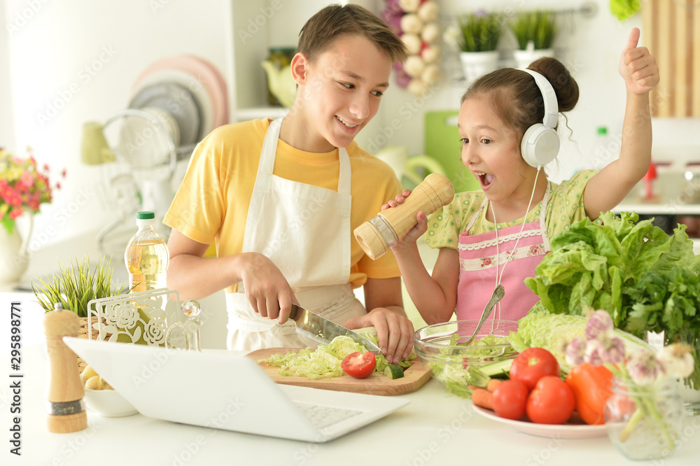 Portrait of cute brother and sister cooking Portrait of cute brother and sister cooking