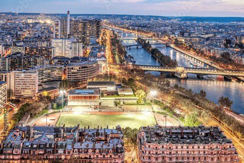 Paris city skyline rooftop view with River Seine at night, France. Evening panorama.
