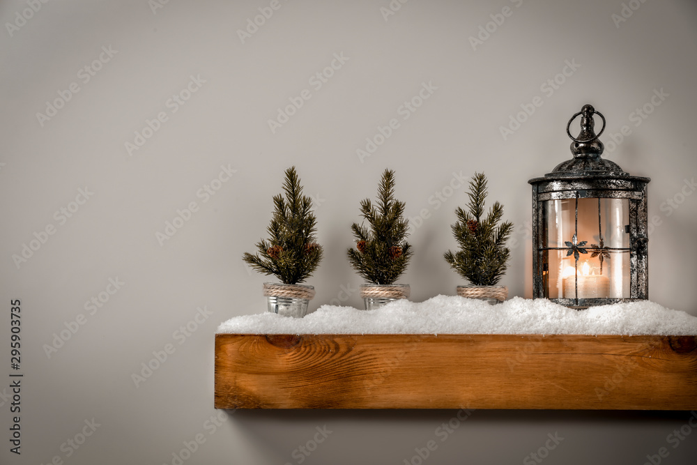 Christmas decorations in bright shiny colors with Christmas lights, picture frames and blurred white wall background.