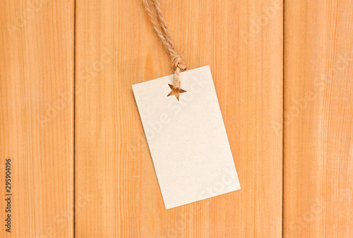 Cardboard price label note on wood mockup. Blank tag with rope. Empty organic style sticker.