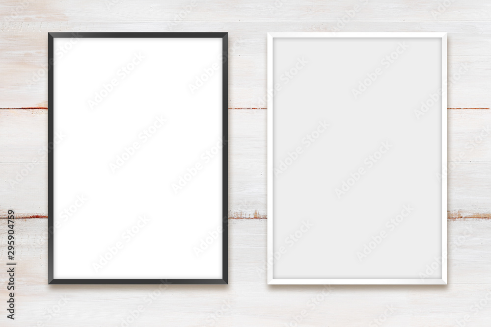 White and black photo frames on a wooden wall