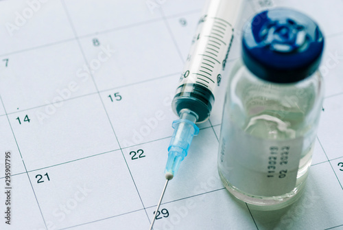Closed vial with vaccine and empty syringe