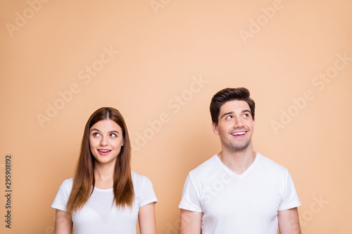 Portrait of his he her she nice attractive lovely curious cheerful cheery smart clever intelligent couple wearing white t-shirt creating solution learning isolated over beige pastel color background
