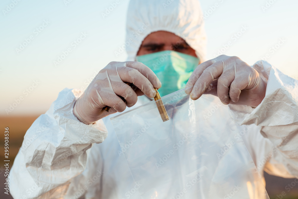 Fototapeta premium Crime scene investigation - collecting bullet of gun on the ground.