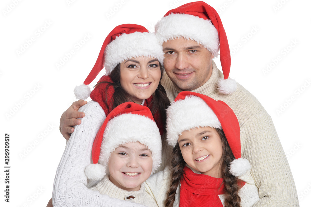 Close up portrait of family with kids in santa hats Close up portrait of family with kids in santa hats