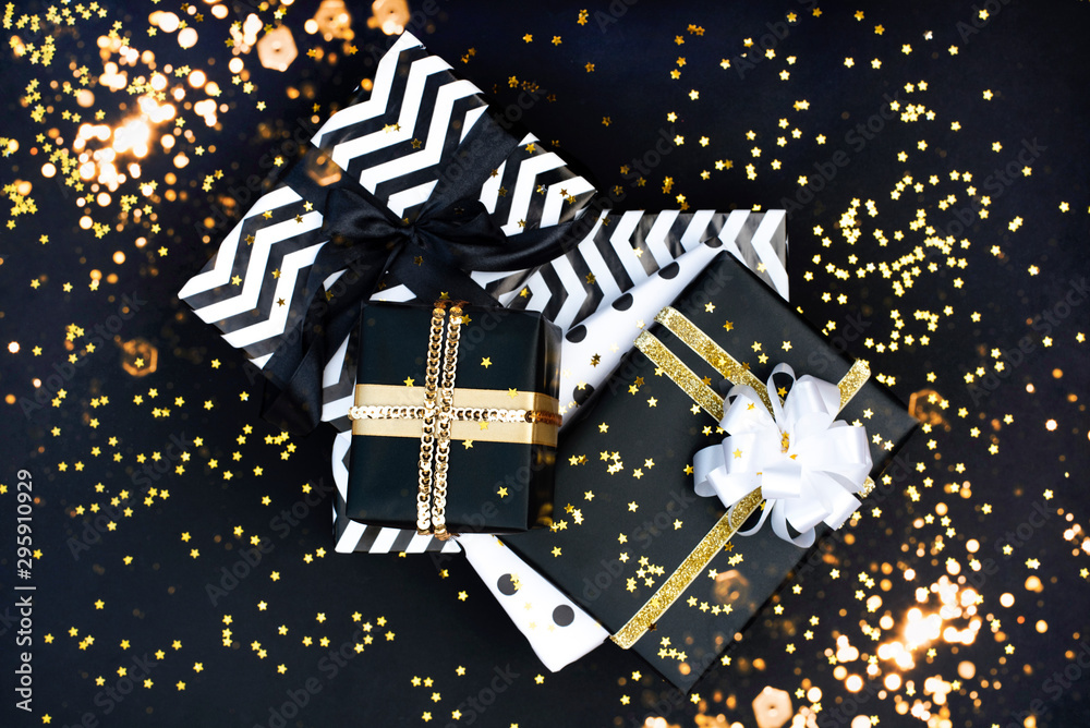 A lot of gifts on a black background with golden stars. A lot of gifts on a black background with golden stars.