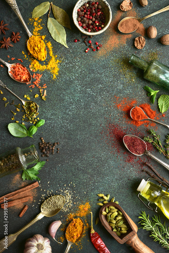 Variety of natural organic spices on a spoons. Top view with copy space.
