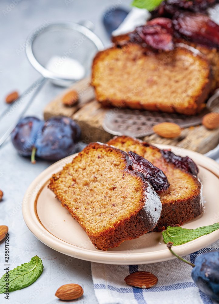 Slices of traditional plum cake on ceramic plate. Slices of traditional plum cake on ceramic plate.