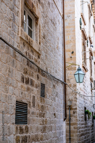 Stone house and lantern in narrow stone street in old historic Dubrovnik city, Dalmatia, Croatia, the most popular touristic destination © Mislav