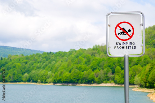 Sign swimming prohibited and icon no swimming near lake shore