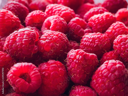 a lot of ripe raspberries close up - food background