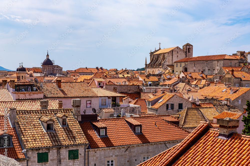 Old stone houses with red roofs in Dubrovnik city stone walls, Dalmatia, Croatia, blue summer day, the most popular touristic travel destination  