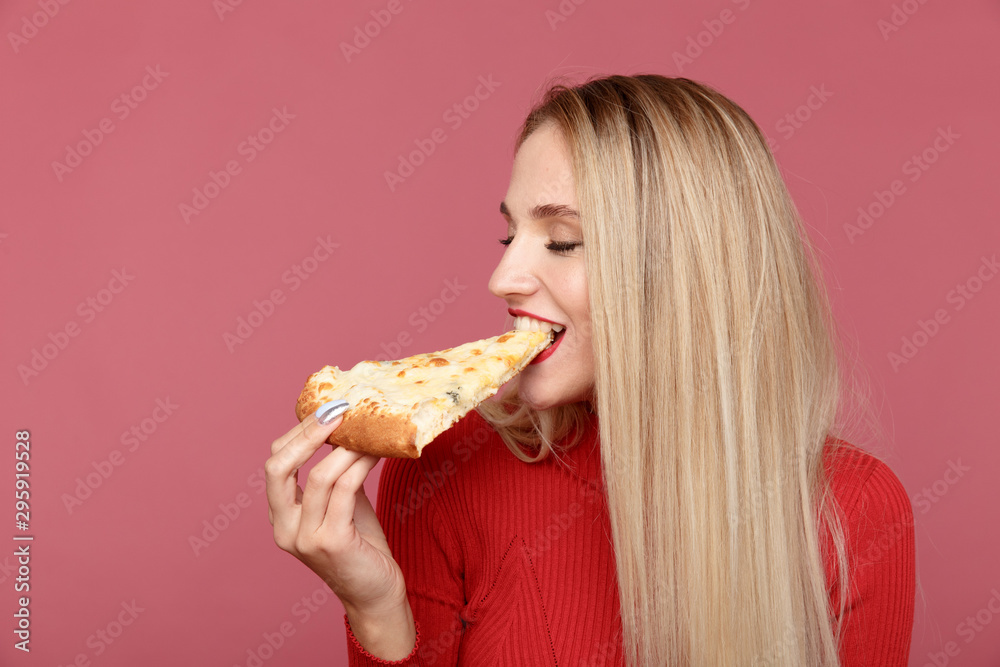 Attractive woman with slice of pizza isolated over the yellow background Attractive woman with slice of pizza isolated over the yellow background