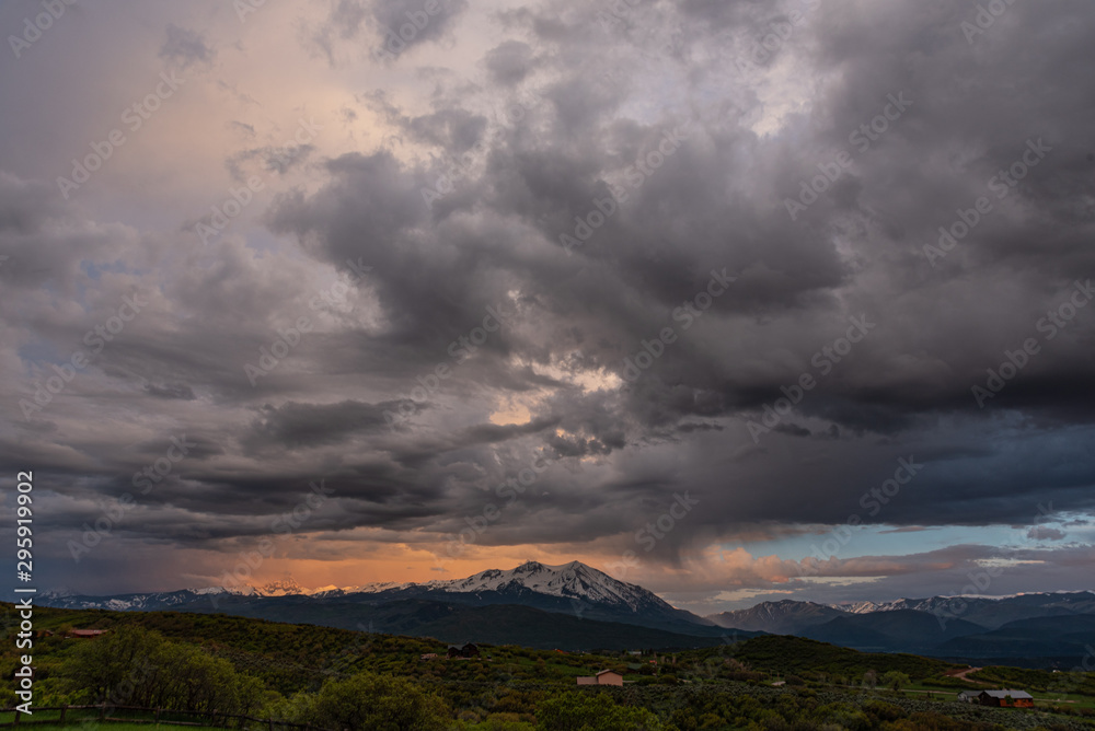 storm clouds and sunset over a mountain