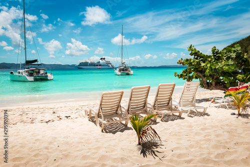 Fototapeta Naklejka Na Ścianę i Meble -  Tropical white sand beach with beach chairs. Jost Van dyke, British Virgin Islands.