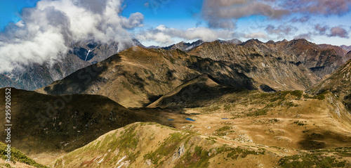 Caucasus mountains range panorama with cloudy sky. Krasnaya Polyana, Sochi, Russia