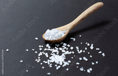 Wooden spoon with salt on black background - Image