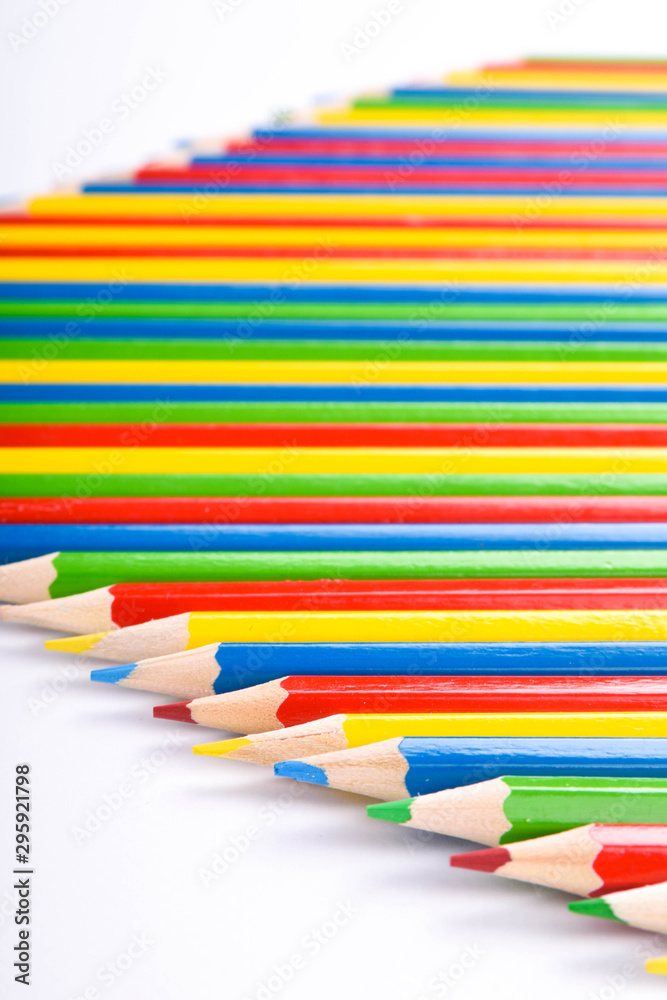Fototapeta premium Many different colored pencils on a white background with a place for text and cory space .