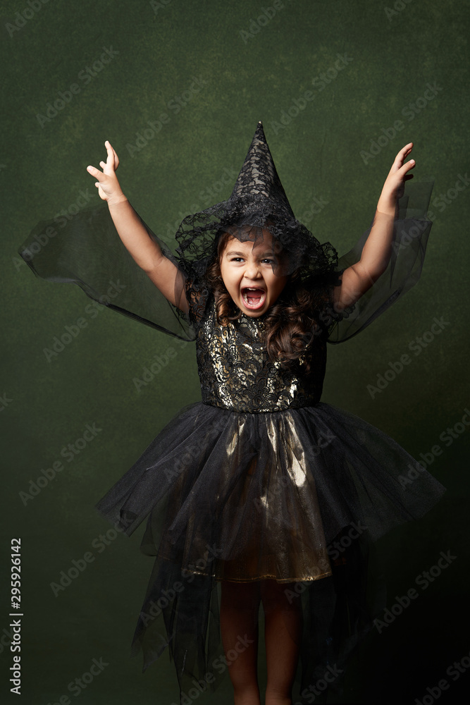 Cute child girl in witch costume for Halloween, close-up Cute child girl in witch costume for Halloween, close-up