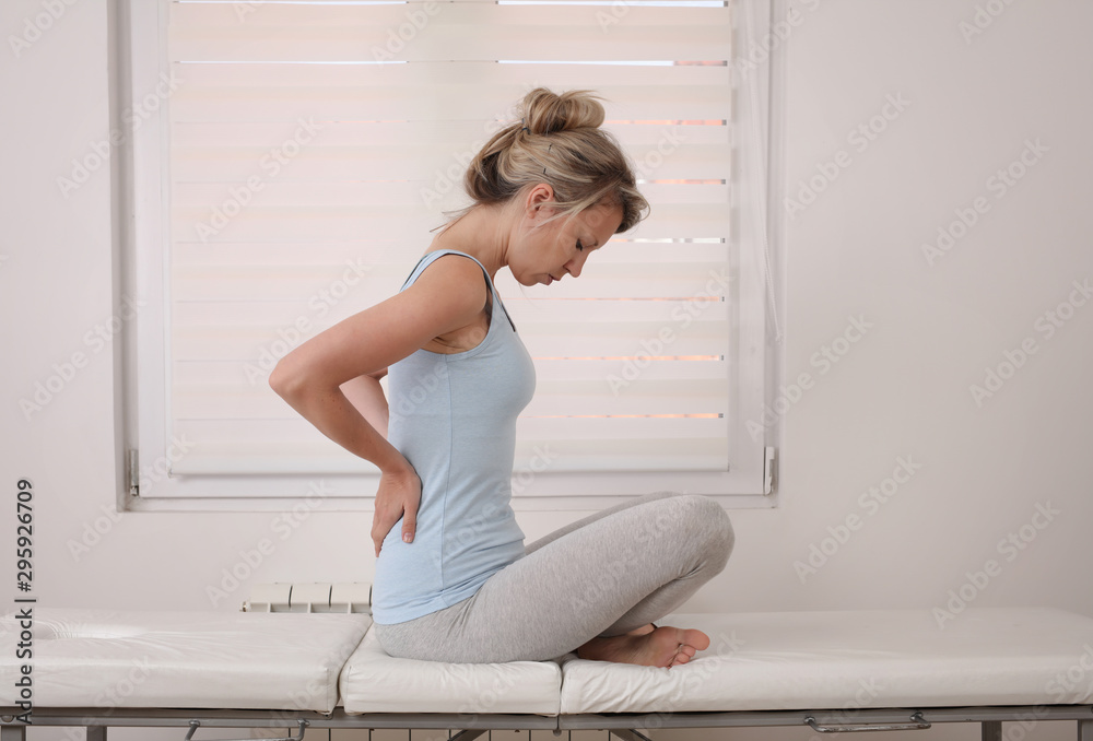 Woman suffering from back and neck pain. Muscle spasm, .Chiropractic concept. Sport exercising injury Woman suffering from back and neck pain. Muscle spasm, .Chiropractic concept. Sport exercising injury