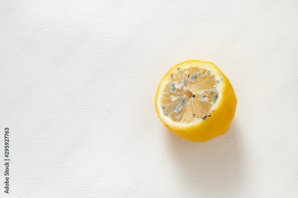 Half spoiled lemon on a white background