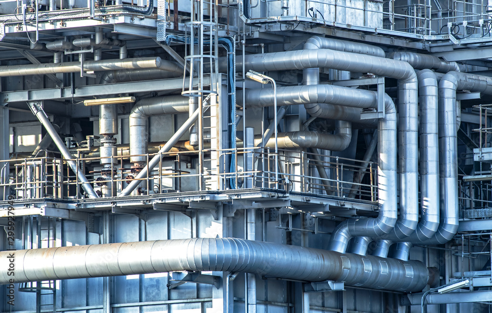 Oil and gas industrial refinery zone,Detail of equipment oil pipeline steel with valve from large oil storage tank at twilight.