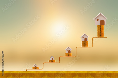 Stacking five gold coin with growing on golden steps and home as destinations on sunlight background, Loan for real estate or buy a new house in the future concept.