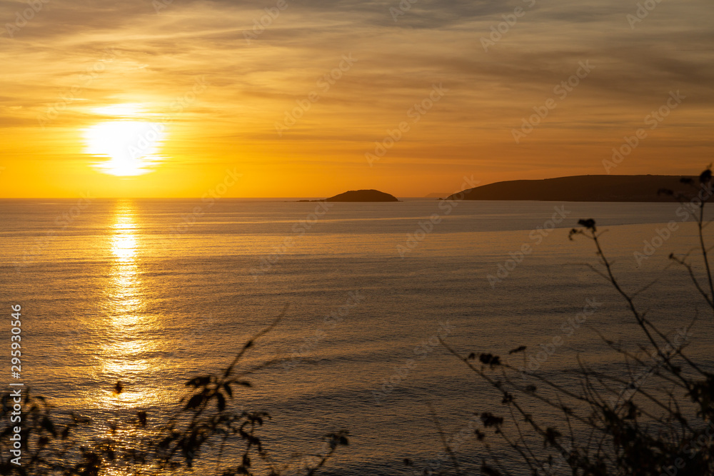 Sunsetting over Whitsand bay with golden light over Looe island Sunsetting over Whitsand bay with golden light over Looe island