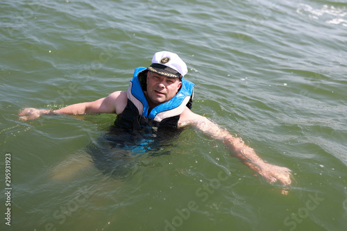 Man in life jacket at sea
