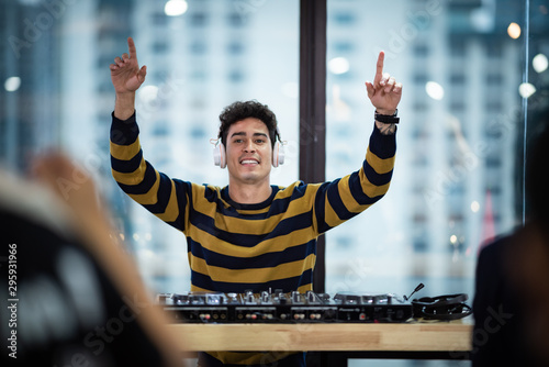 Male DJ playing music in party