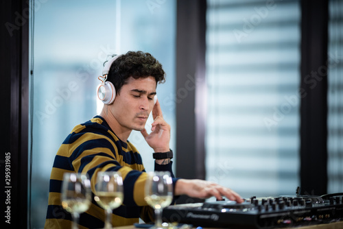 Male DJ playing music in party