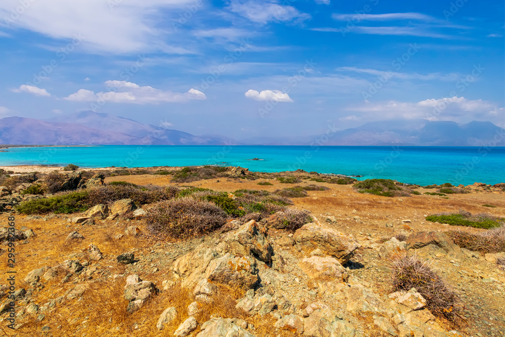 abandoned beach , rocks on coast, beautiful turquoise sea , deep blue sky with clouds and mountains on background, Mediterranean landscape