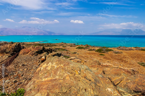 abandoned beach , rocks on coast, beautiful turquoise sea , deep blue sky with clouds and mountains on background, Mediterranean landscape