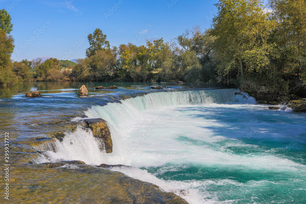 Fototapeta premium under a bright blue sky you can see the waterfall of Manavgat