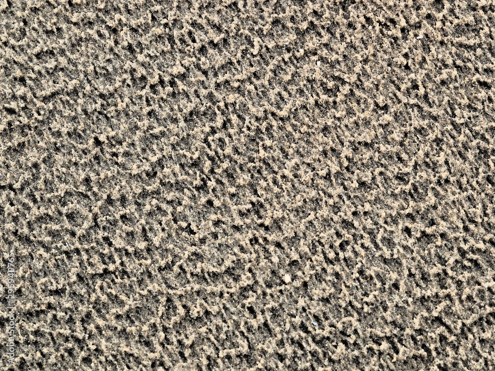 Beach sand pattern on fine and moist sand at low tide Beach sand pattern on fine and moist sand at low tide