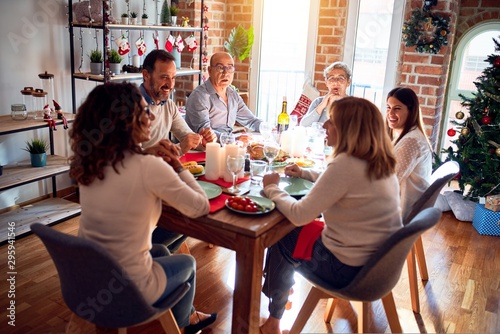 Family and friends dining at home celebrating christmas eve with traditional food and decoration  celebration of festive winter time