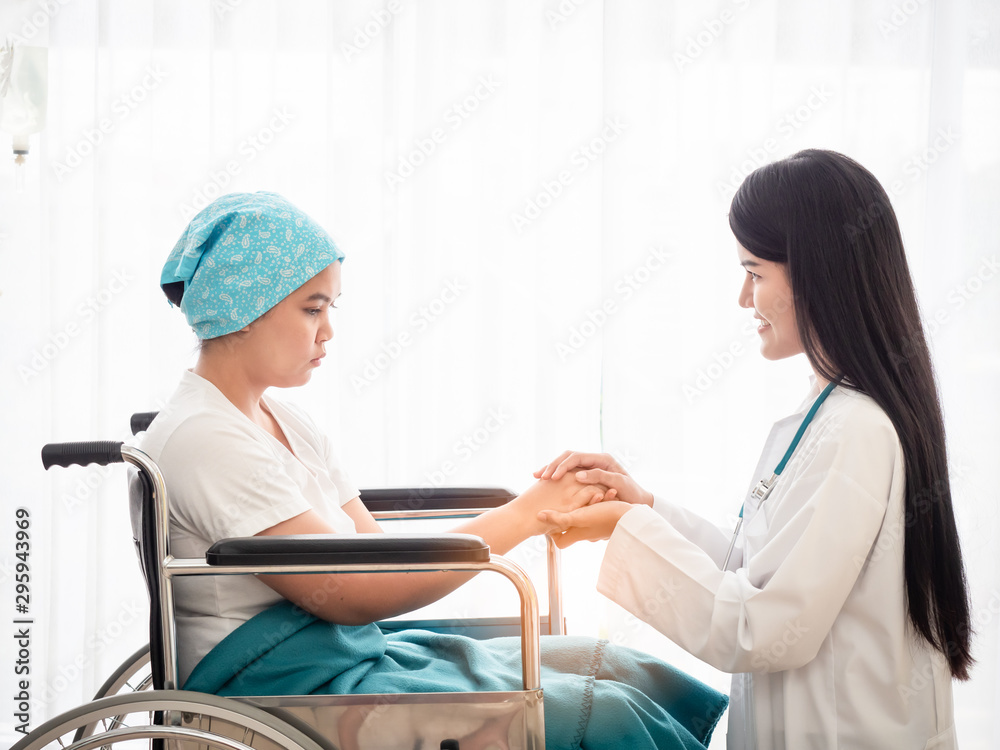Obraz premium Doctor holding patient's hand together over white background,helping hand and encouragement together with kindess and liberality.