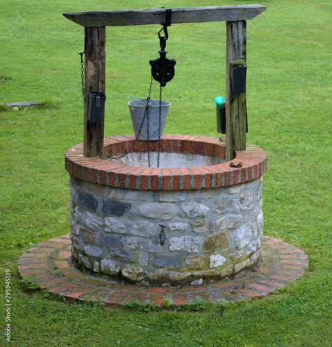 A well made of stone in a garden photo