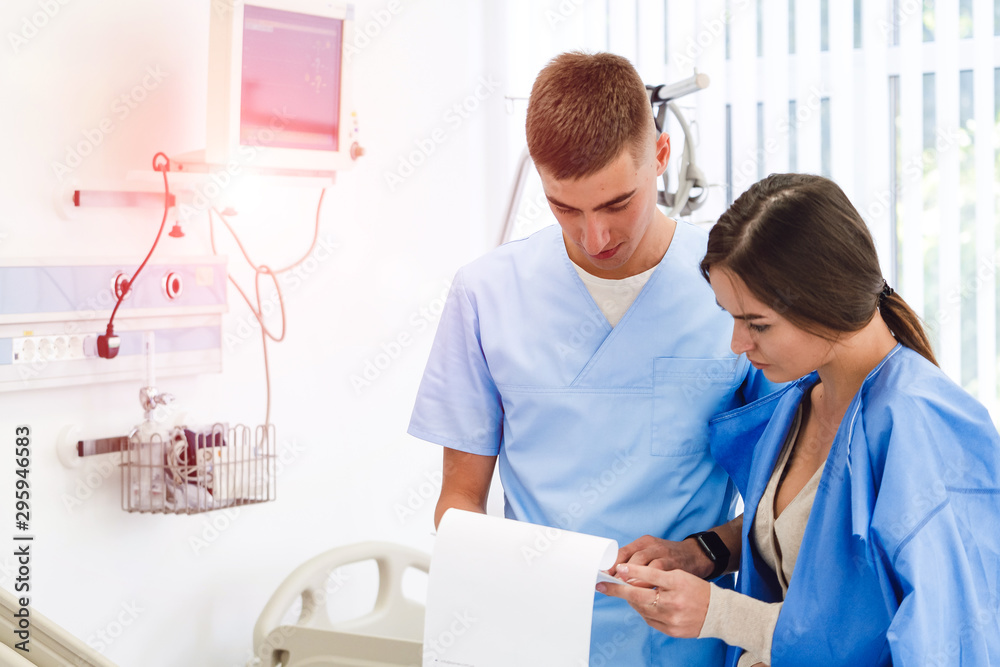 Fototapeta premium Doctor physician consulting with female patient in hospital exam room. Checking medical results. Medical treatment. Clinic.