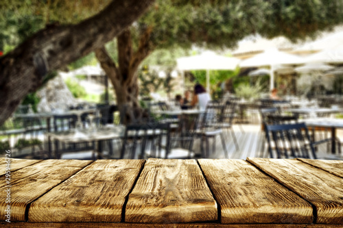 Table background  in a restaurant outdoor view. Empty  space for your decoration and an advertising product. © magdal3na