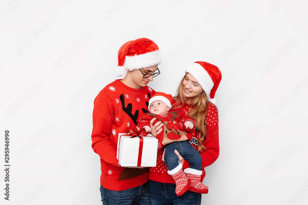 Happy family, mom, dad and little baby with christmas gifts isolated on white background Happy family, mom, dad and little baby with christmas gifts isolated on white background