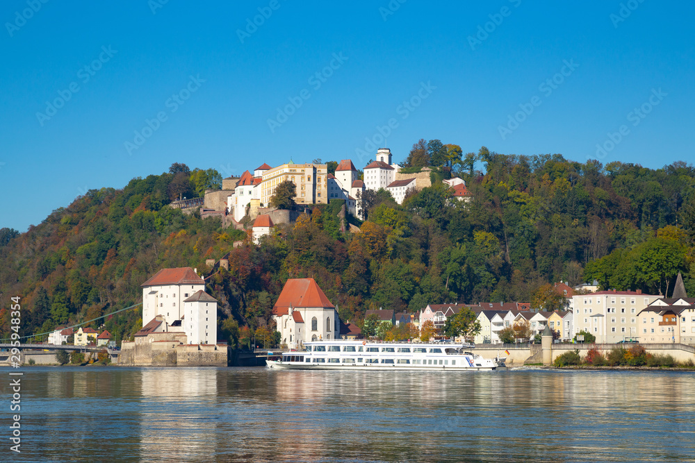 River cruising on river Danube in front of Oberhaus castle in Passau, Germany