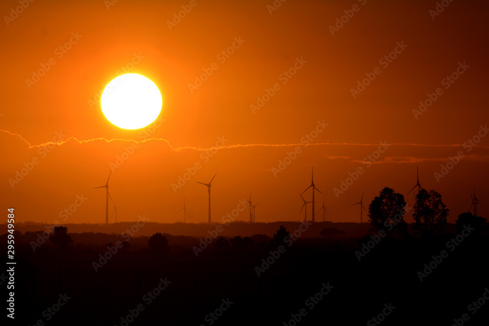 Silhouetes of windmills on a sunset, in Osório Wind Farm, Rio Grande do Sul, Brazil