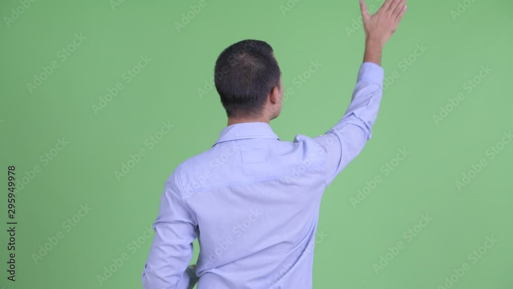 Rear view of Asian businessman touching something Rear view of Asian businessman touching something