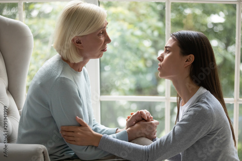 Fotografie Upset empathic young lady showing support to mother.
